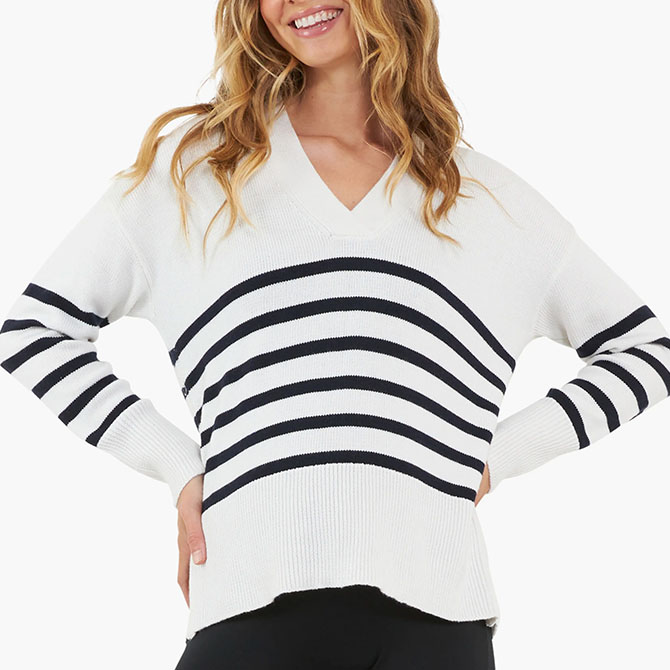 White sweater with dark strips.
