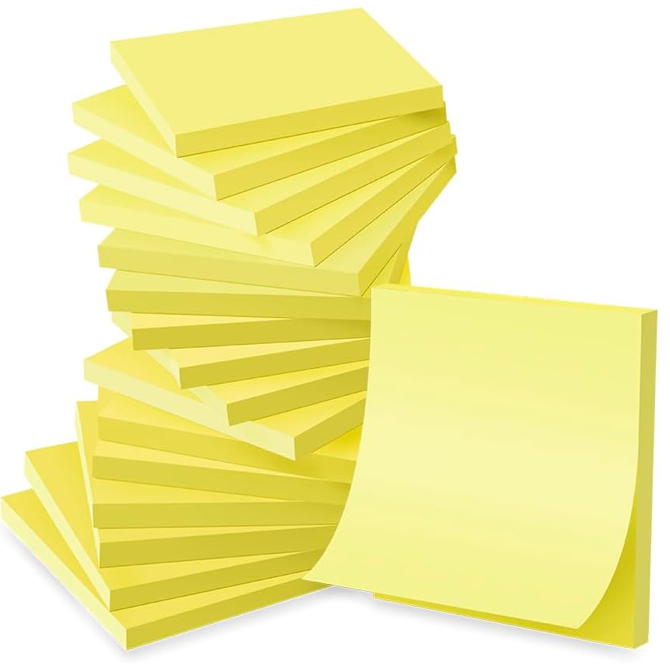 A pad of yellow sticky notes next to a pile of yellow sticky notes.