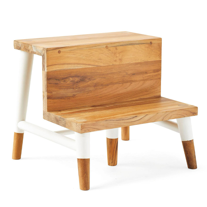 A wood step stool with white legs and two steps.