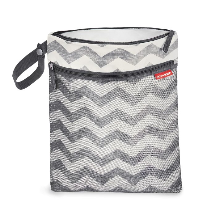 Grey and white chevron bag with black zippers.